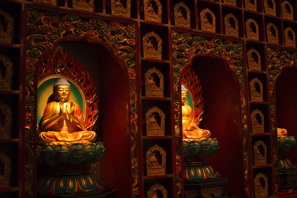 gold buddha figurine on brown wooden shelf