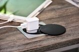 white charger adapter on brown wooden table
