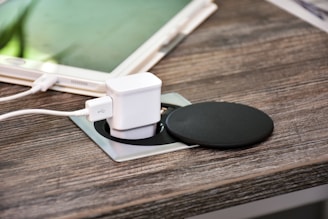 white charger adapter on brown wooden table