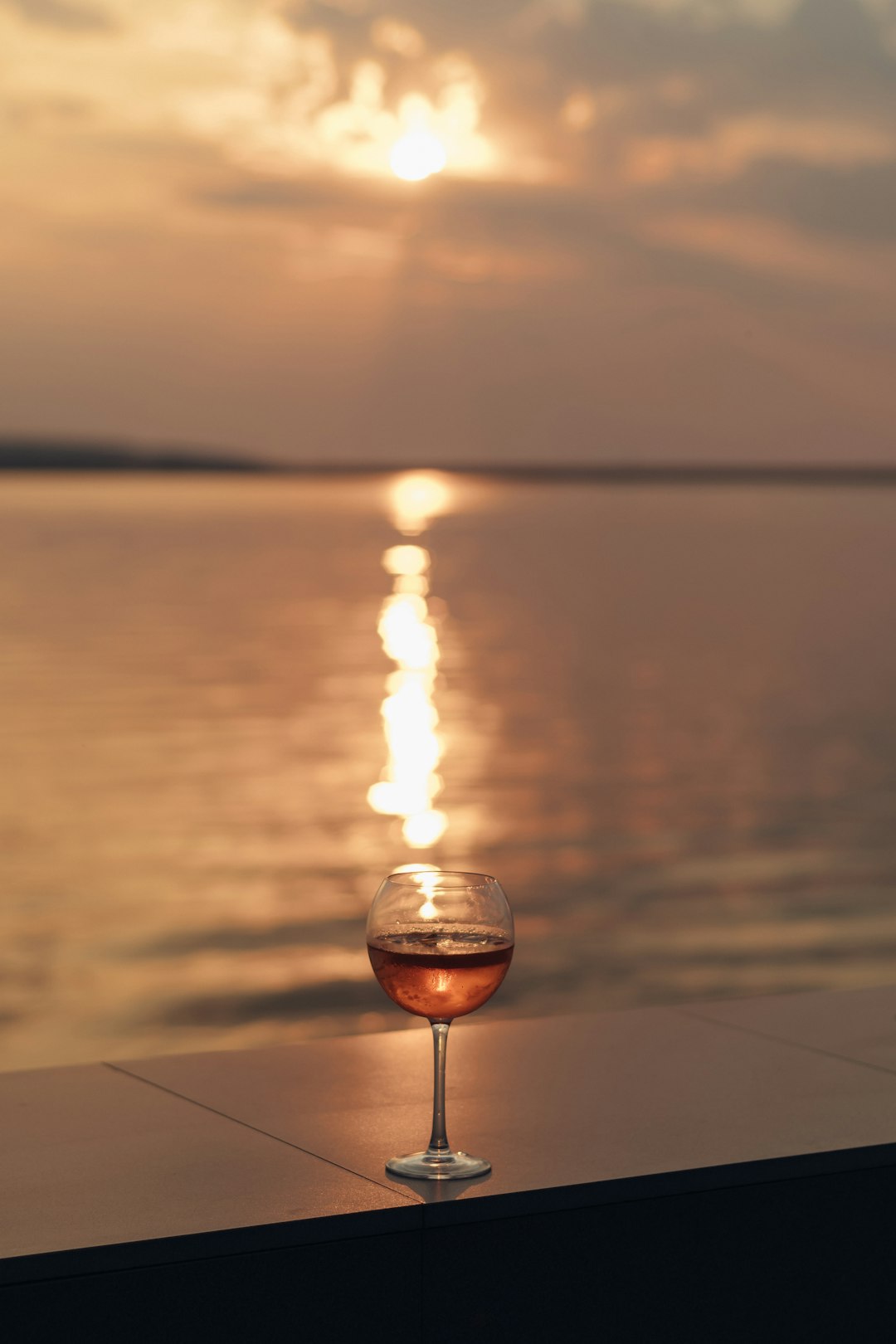 clear glass ball on brown wooden table during sunset