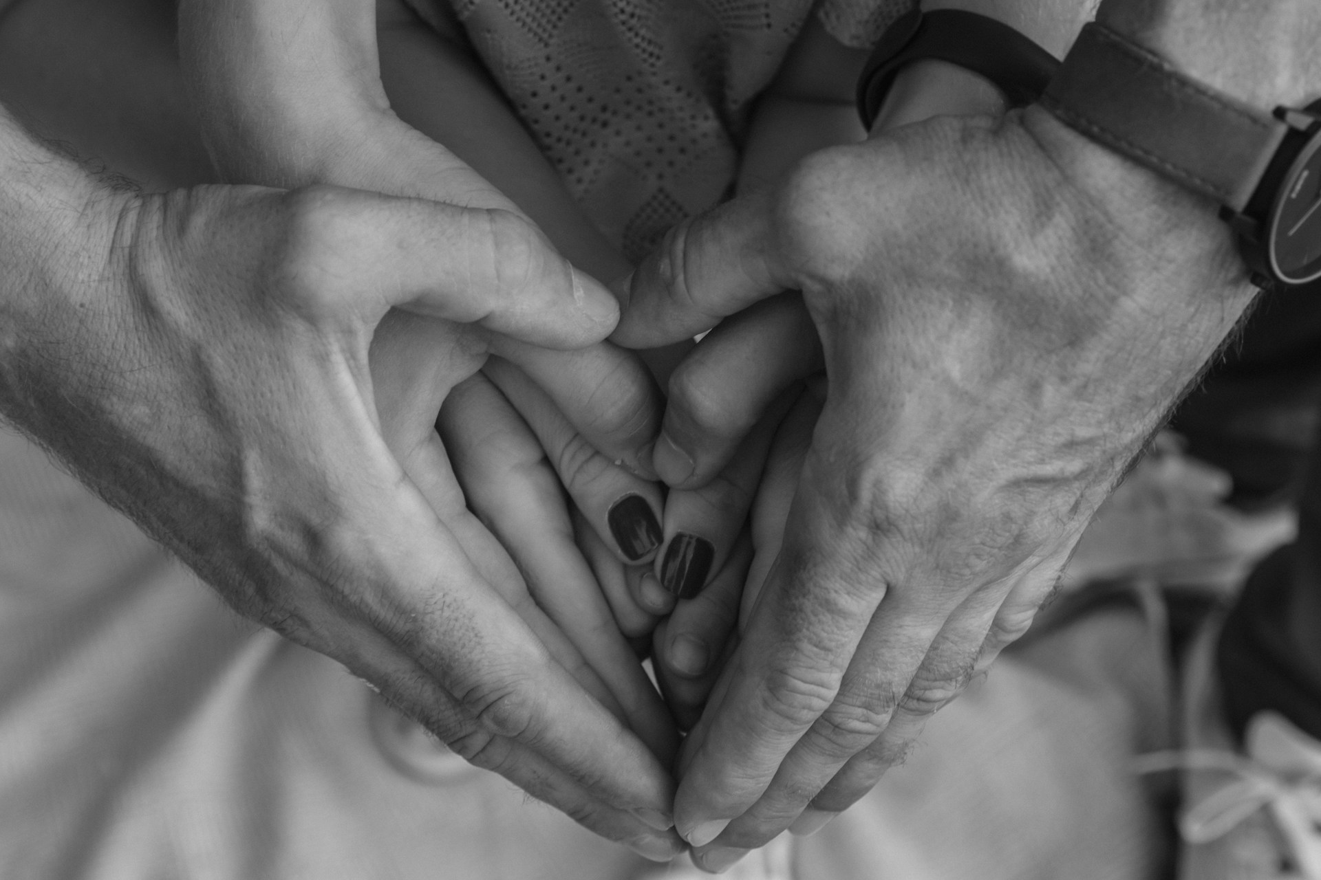 grayscale photo of couple holding hands