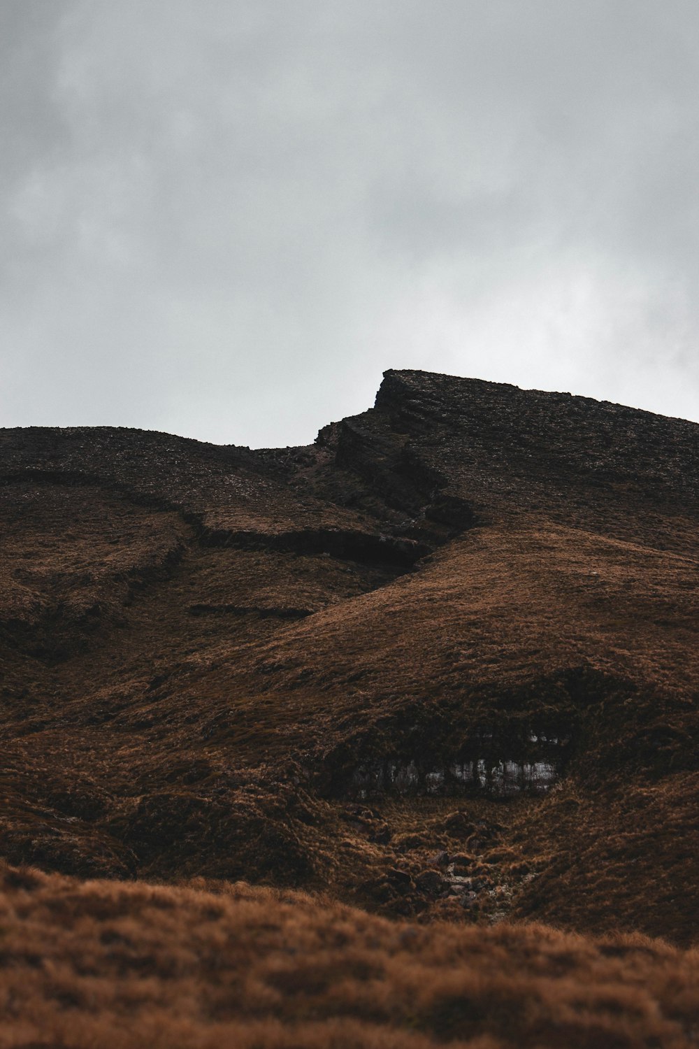 brown mountain under white clouds