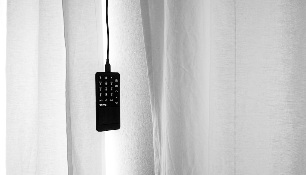 black remote control on white textile