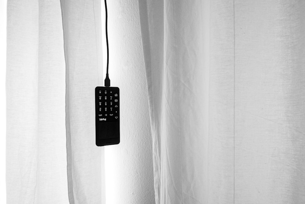 black remote control on white textile