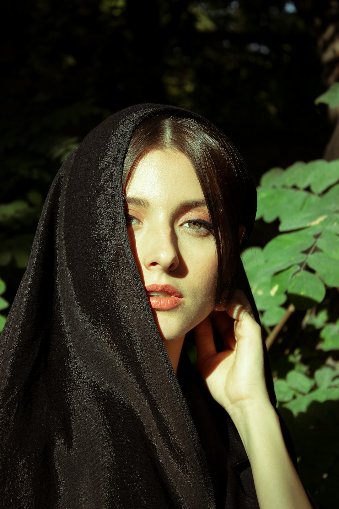 woman in black hijab covering her face with black textile