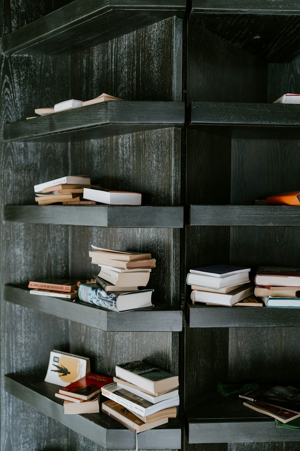 books on black wooden shelf