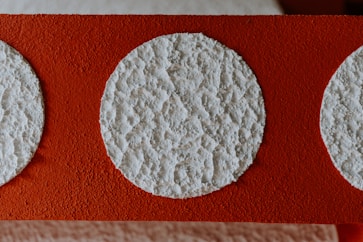 white round ornament on red textile