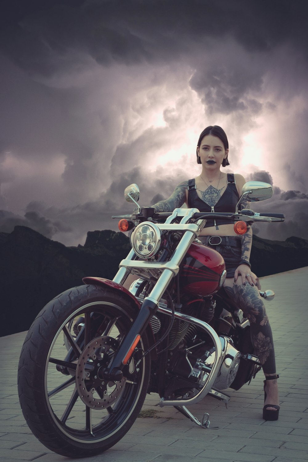 boy in black jacket riding on red motorcycle