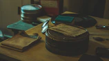 A cinematic shot of a dimly lit studio space with scattered scripts, a vintage typewriter, and warm muted lighting.