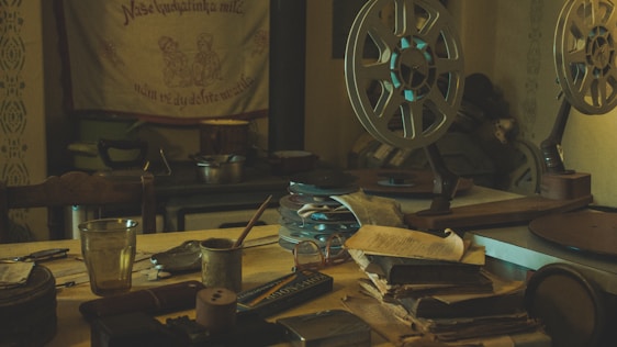 A cozy film studio workspace with vintage cameras, film reels, and a group of passionate filmmakers collaborating.
