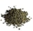 A pile of tightly rolled tea leaves with a textured and irregular surface, predominantly green in color, scattered over a white background.