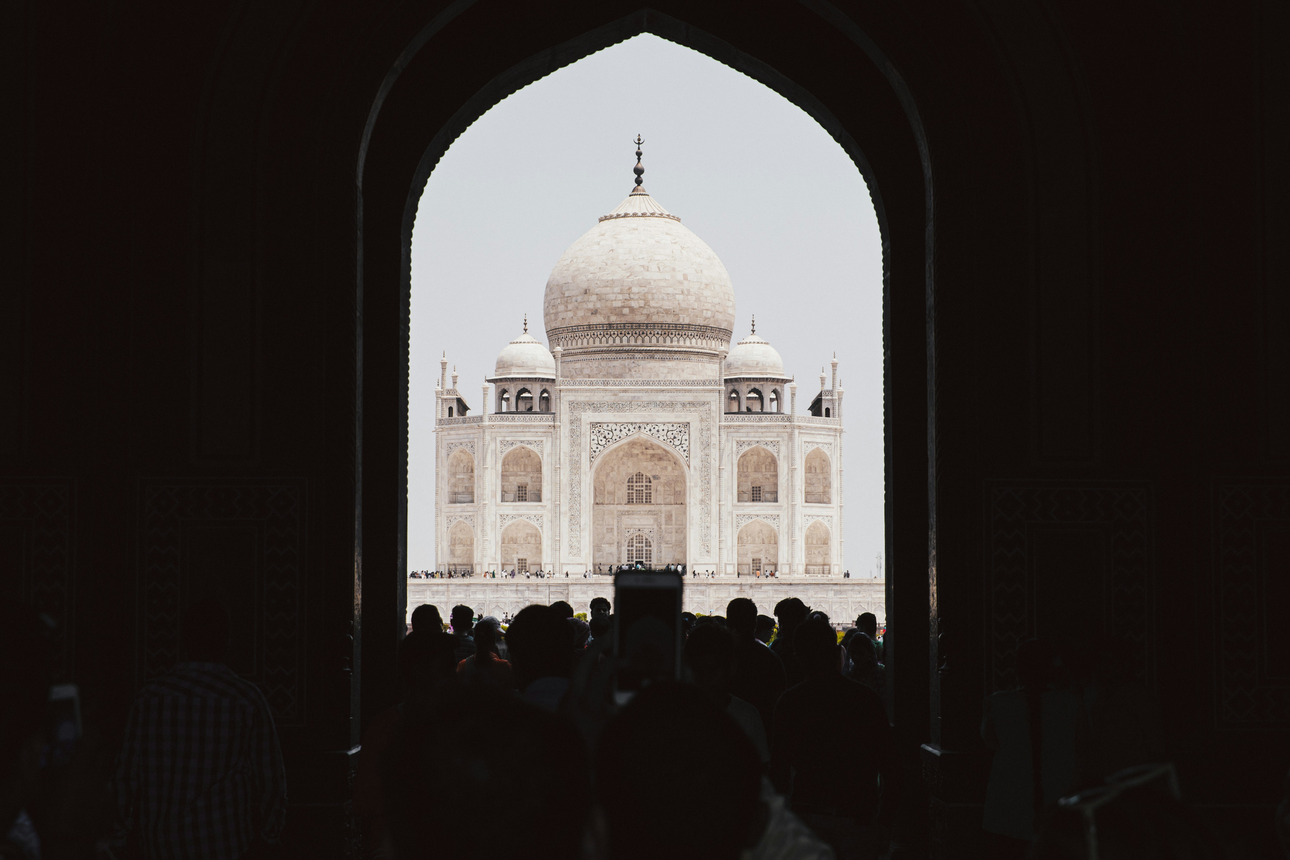 people in front of white concrete building during daytime