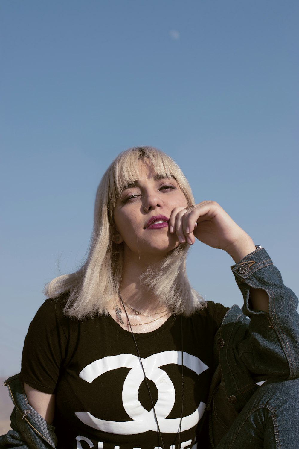 woman in black and white crew neck shirt with blue denim jacket