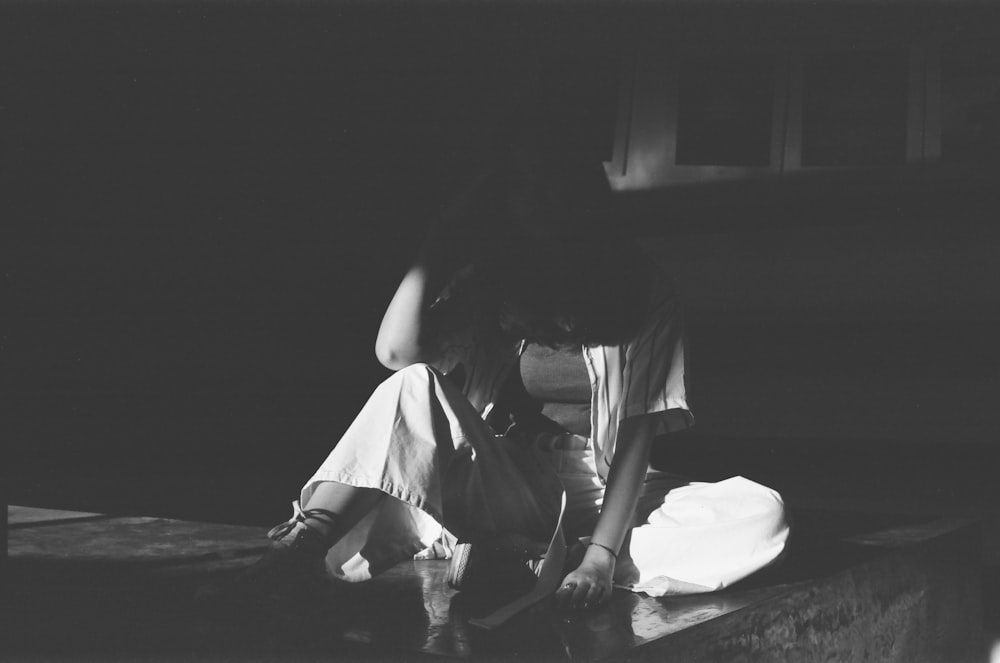 woman in white dress sitting on floor