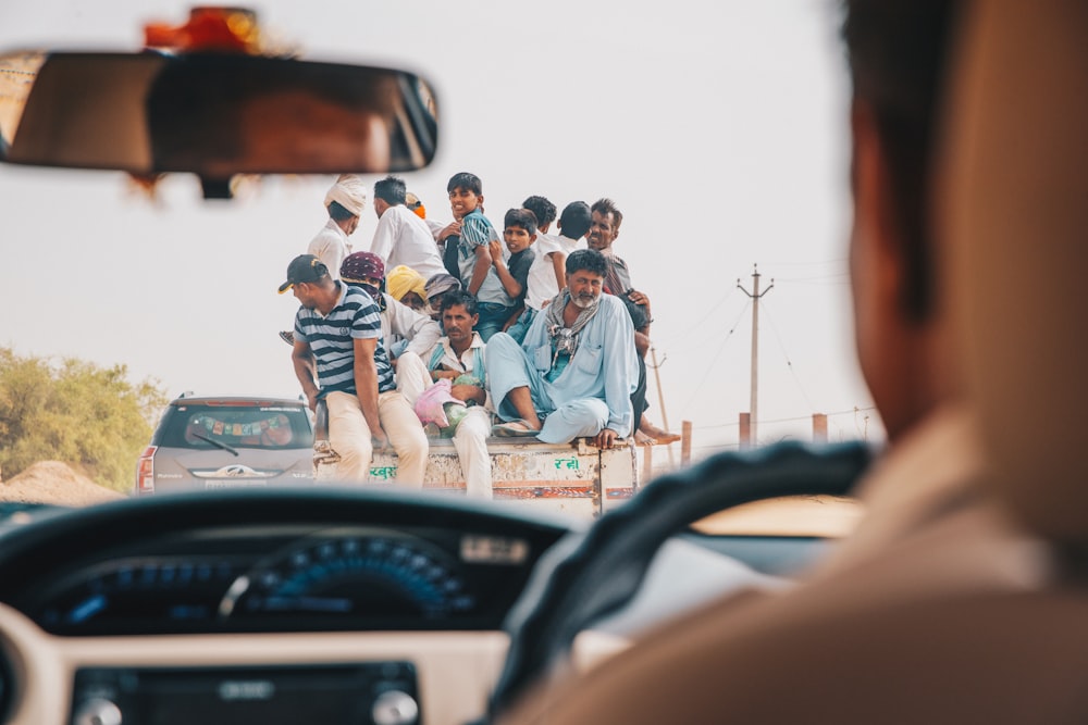 people standing beside black car during daytime