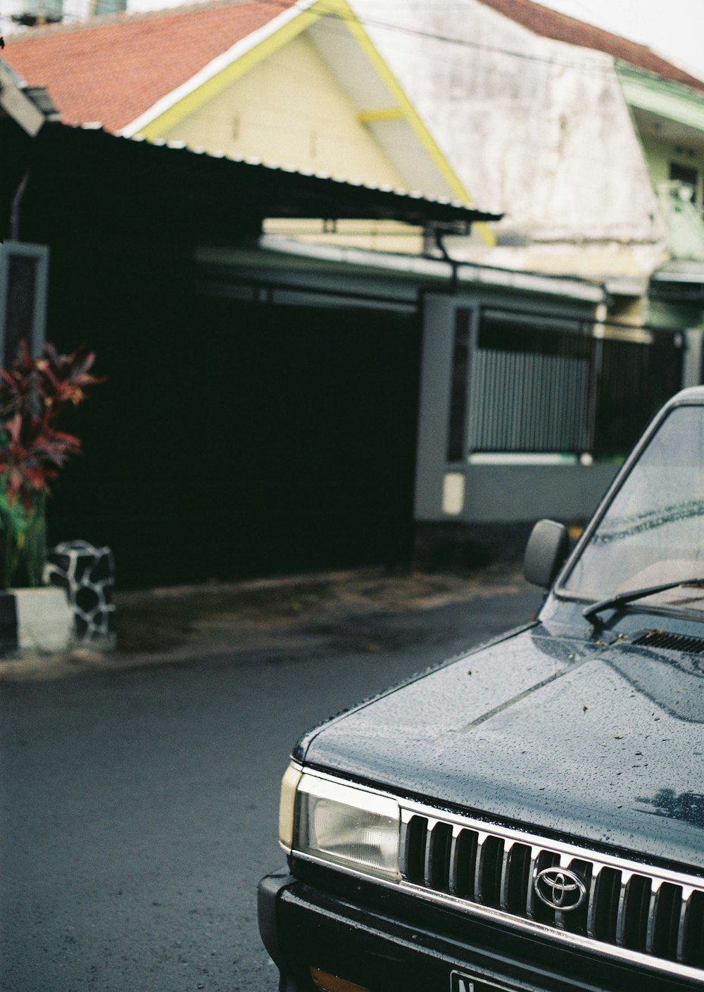 black car parked near house