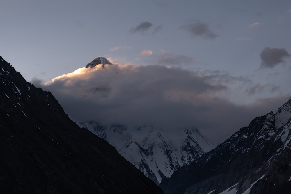 black and white mountain under white clouds