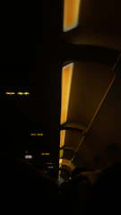A cozy economy class cabin with comfortable seats and warm lighting, showing passengers enjoying their flight.