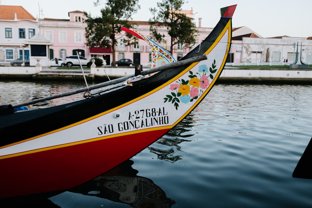 red and black boat on water during daytime