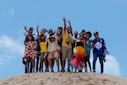 group of people standing on brown sand during daytime