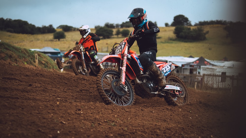 man in black and red motorcycle suit riding red and white motocross dirt bike