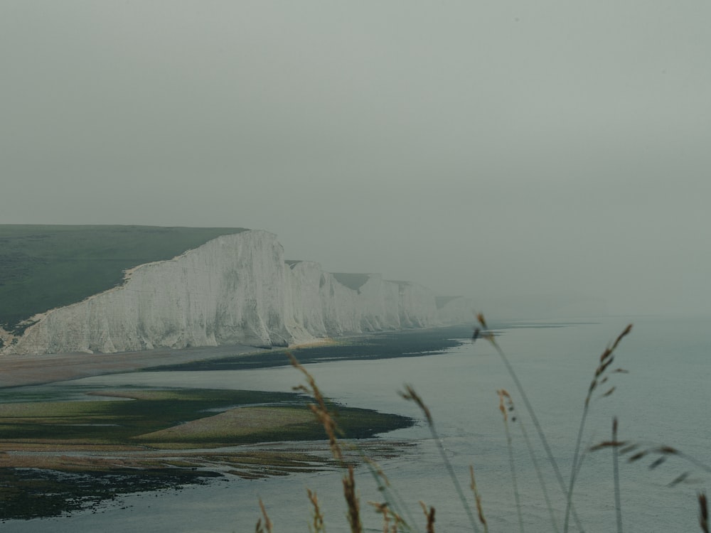 white and gray mountain near body of water