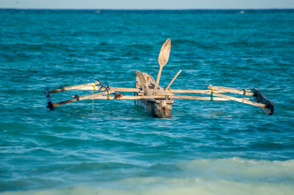 brown wooden boat on blue sea during daytime