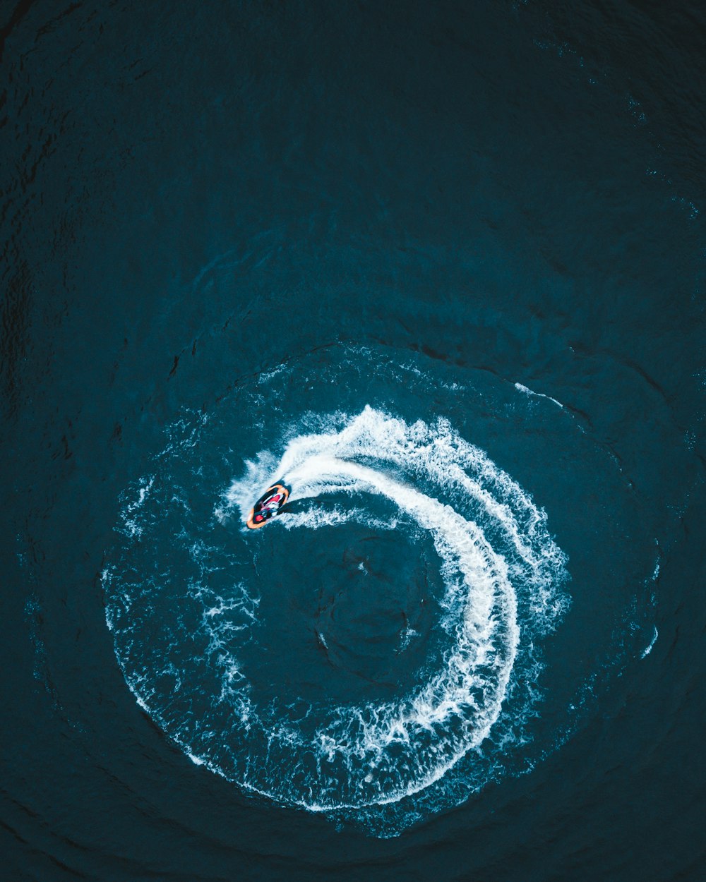 person surfing on blue water