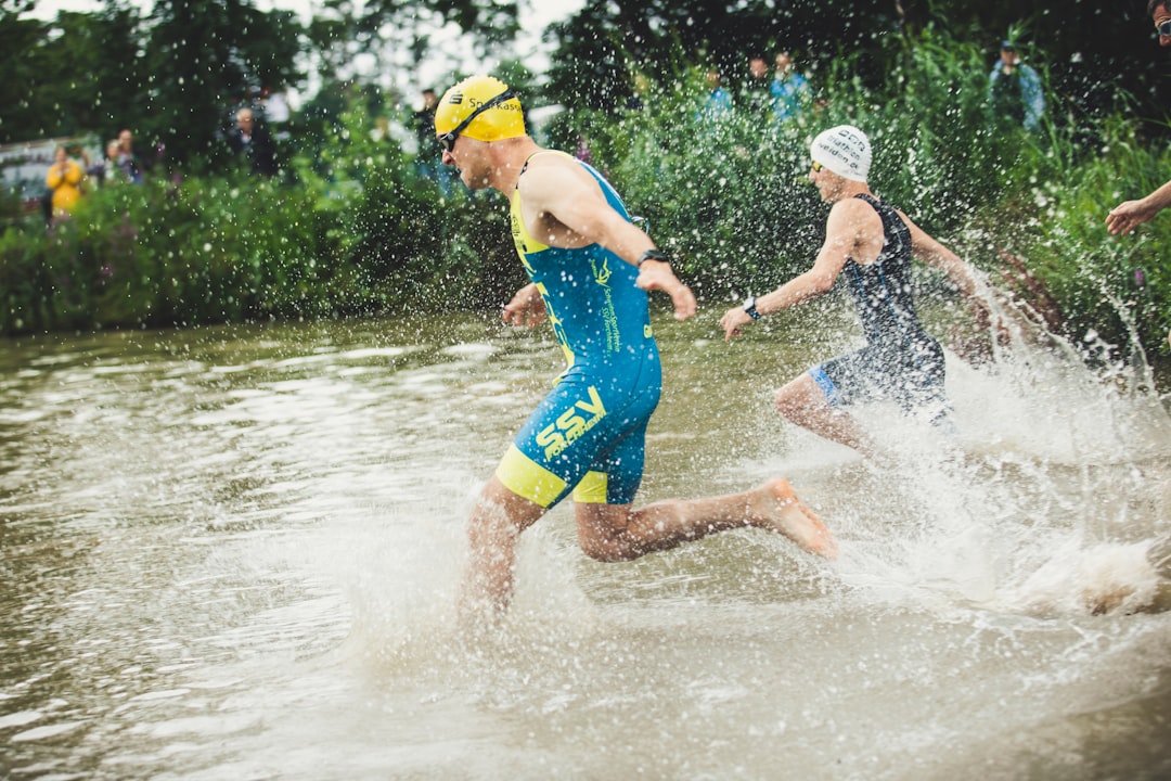 man in blue shorts running on water during daytime