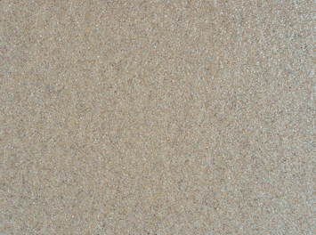 Shiny, translucent silica sand grains spread across a surface.