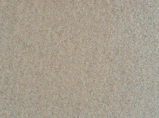 Shiny, translucent silica sand grains spread across a surface.