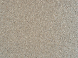 Close-up of fine, golden Australian silica sand grains sparkling under natural light.