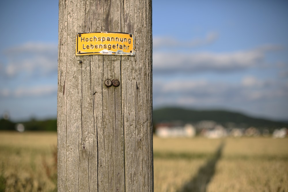 brown wooden signage on brown wooden post