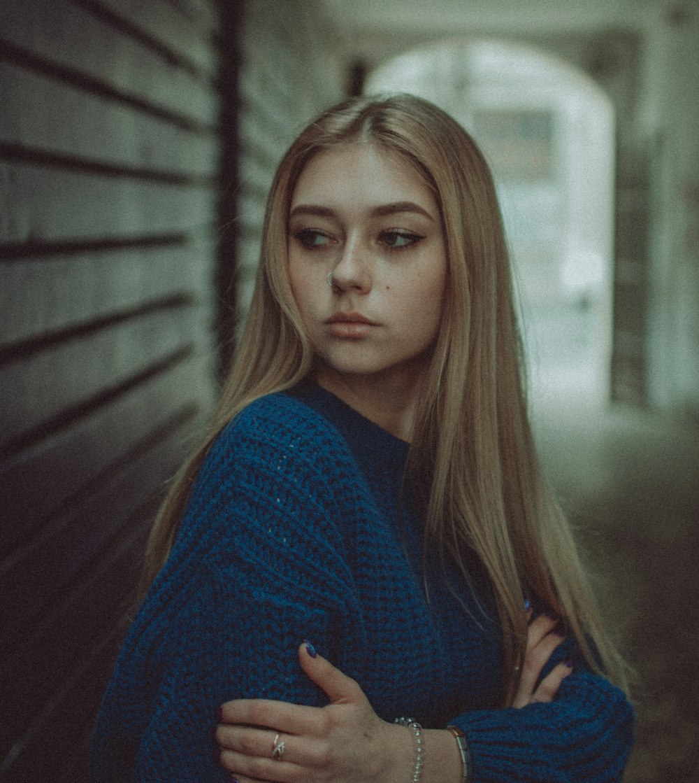 woman in blue sweater standing