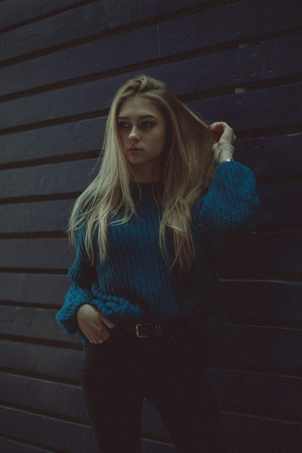 woman in blue sweater and black pants