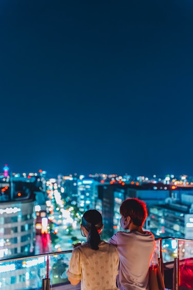 woman in white shirt standing on the city during night time