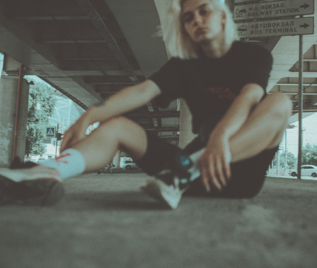 woman in black shirt sitting on floor