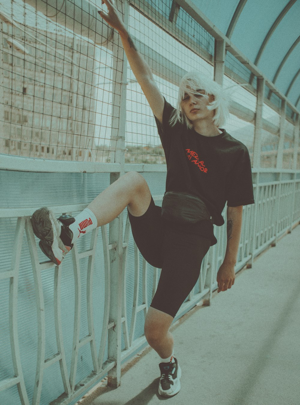 woman in black tank top and white shorts holding white and red basketball