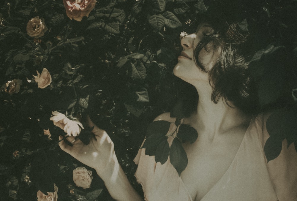 woman in white dress holding white flower