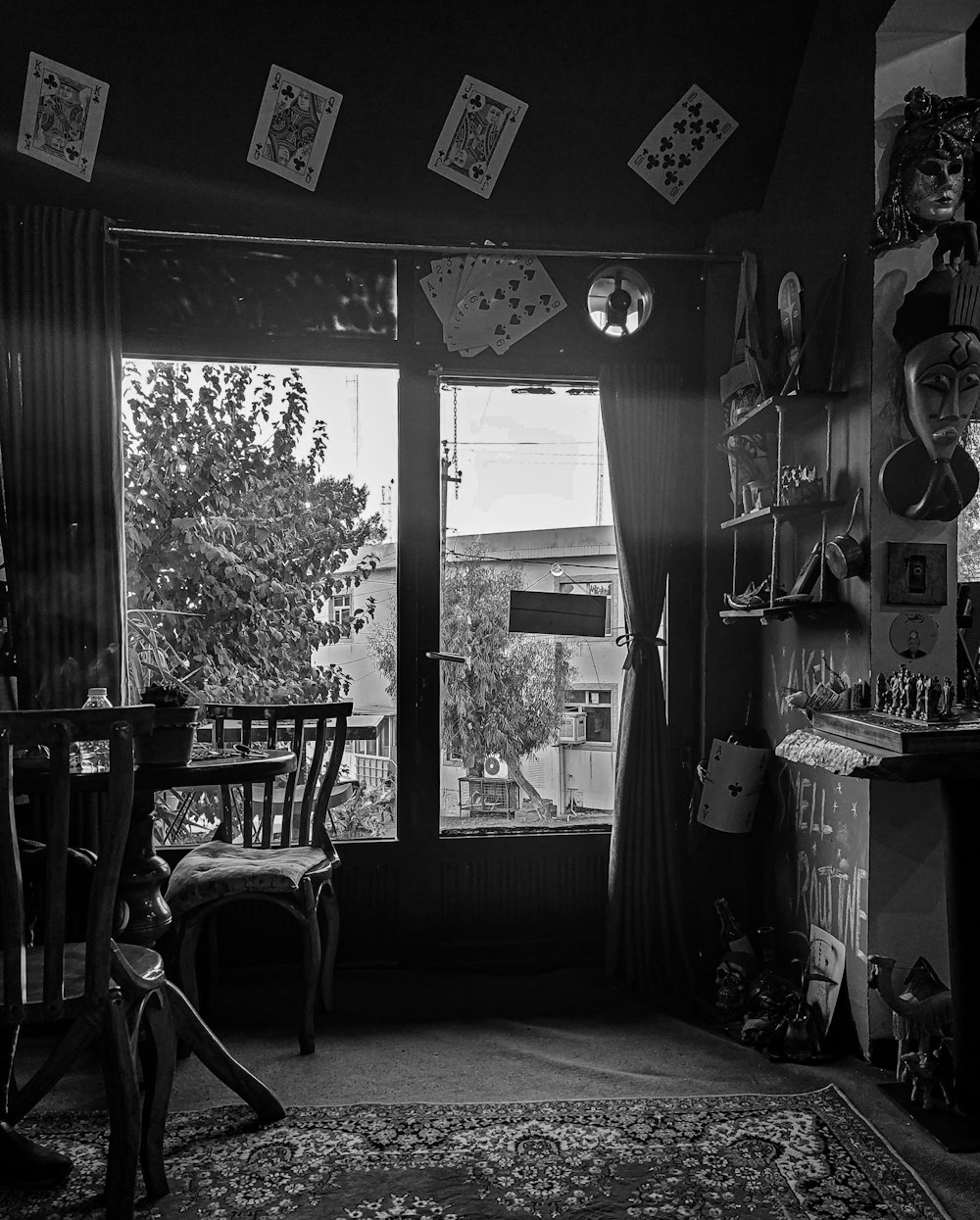 grayscale photo of dining table and chairs