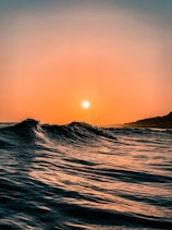 body of water during sunset