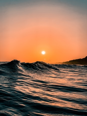 body of water during sunset