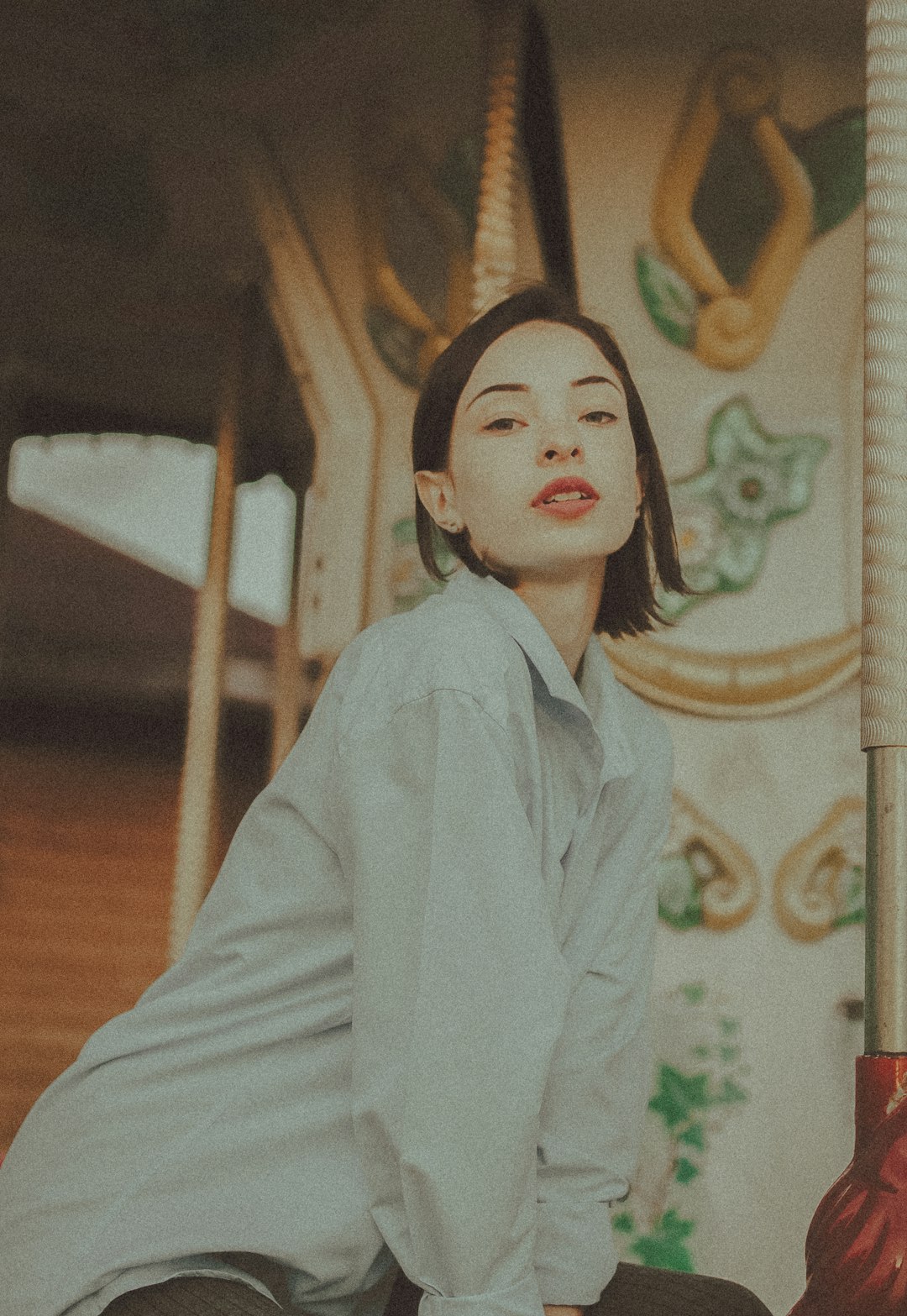 woman in white robe standing near brown wooden wall