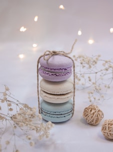 Delicate pastel macarons stacked neatly on a vintage cake stand with soft natural light.