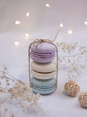 Delicate pastel macarons stacked neatly on a vintage cake stand with soft natural light.