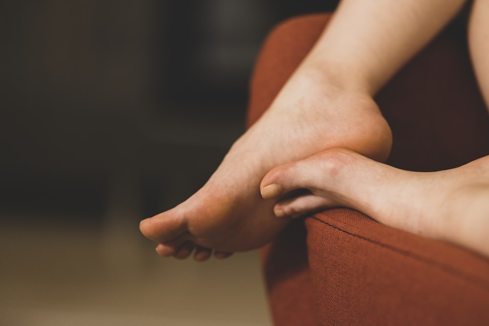 persons feet on brown textile