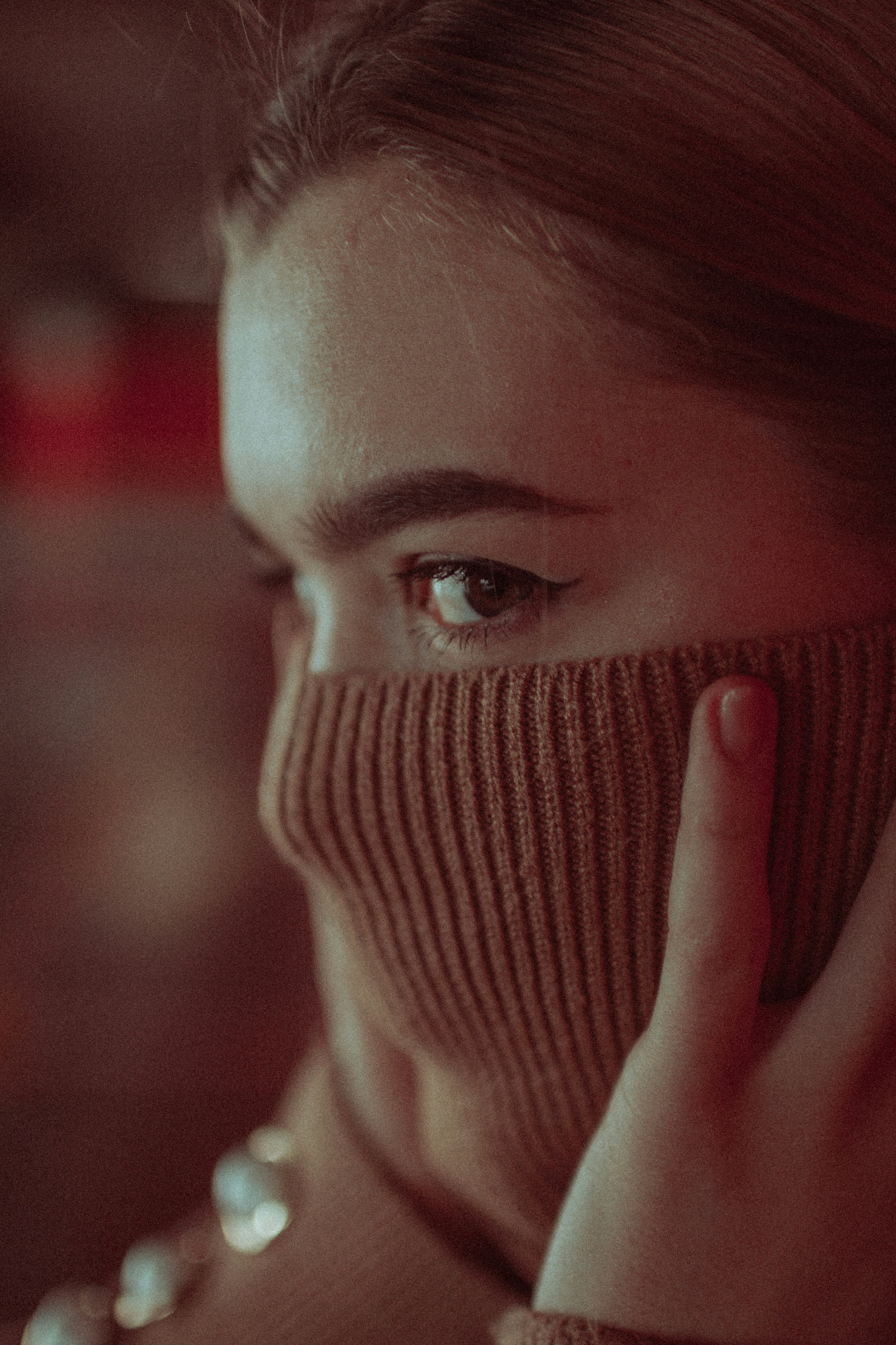 woman covering her face with her hand