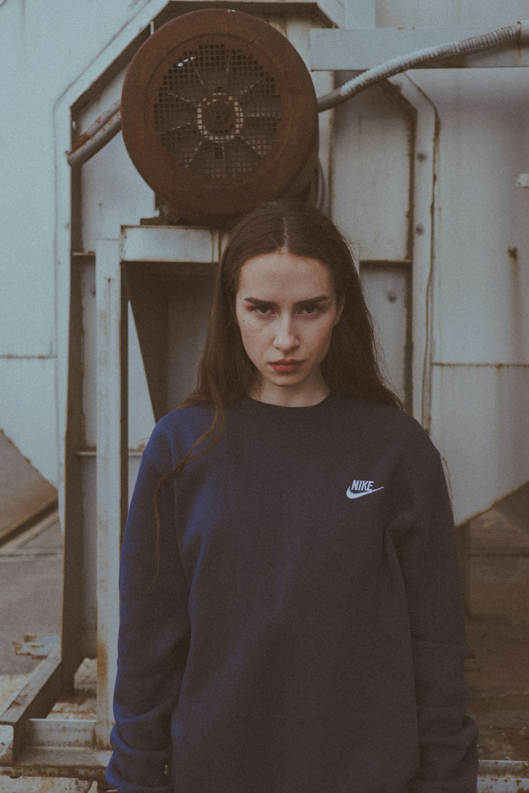 woman in blue long sleeve shirt standing near white wooden door