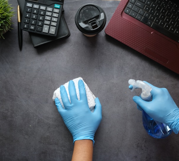 person in blue long sleeve shirt sitting beside black laptop computer