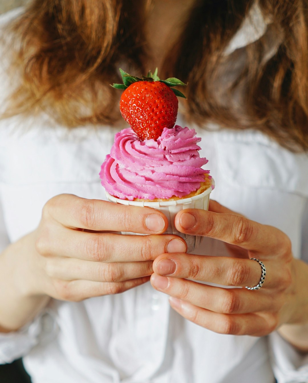 woman holding strawberry ice cream